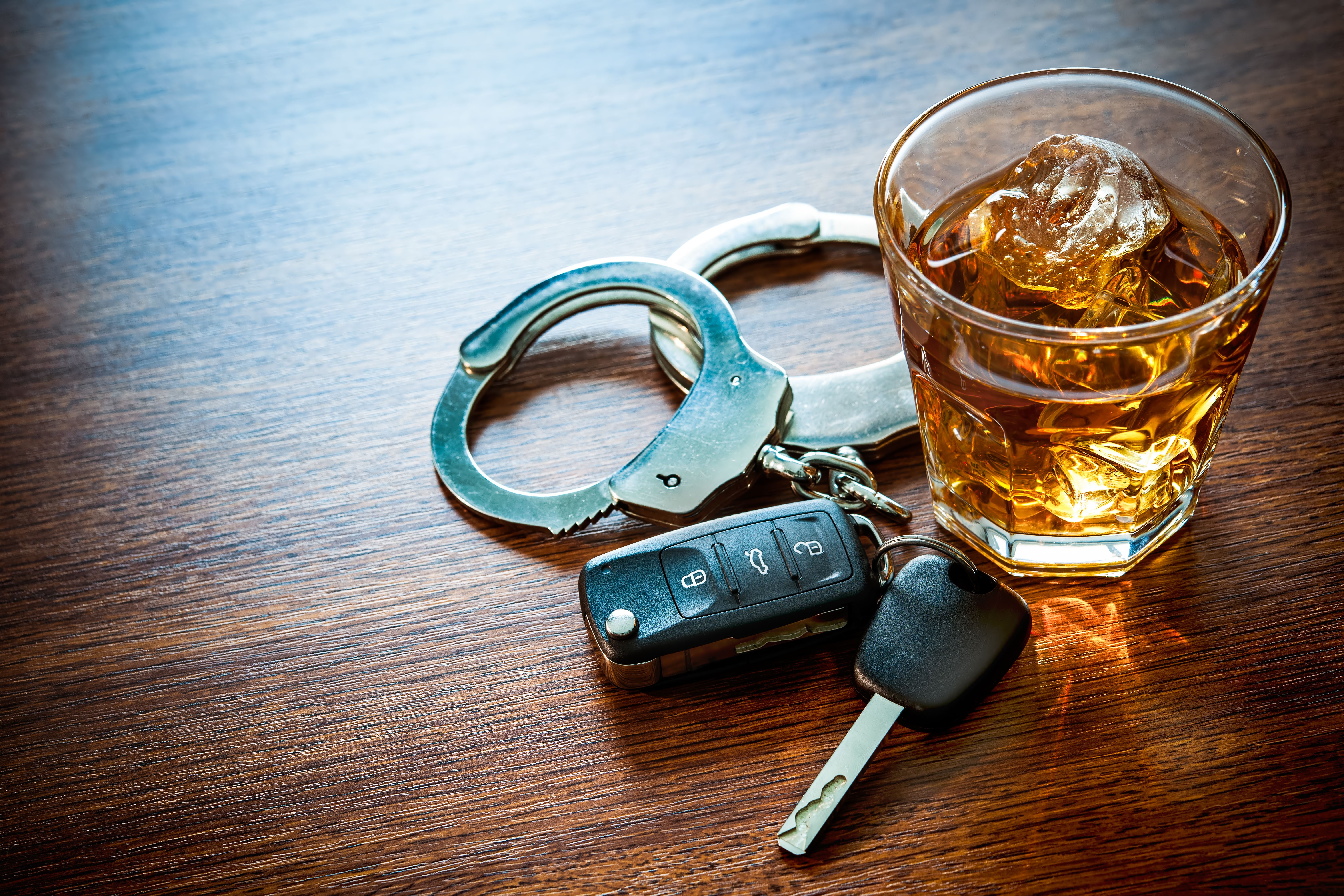 whiskey, handcuffs, and car keys